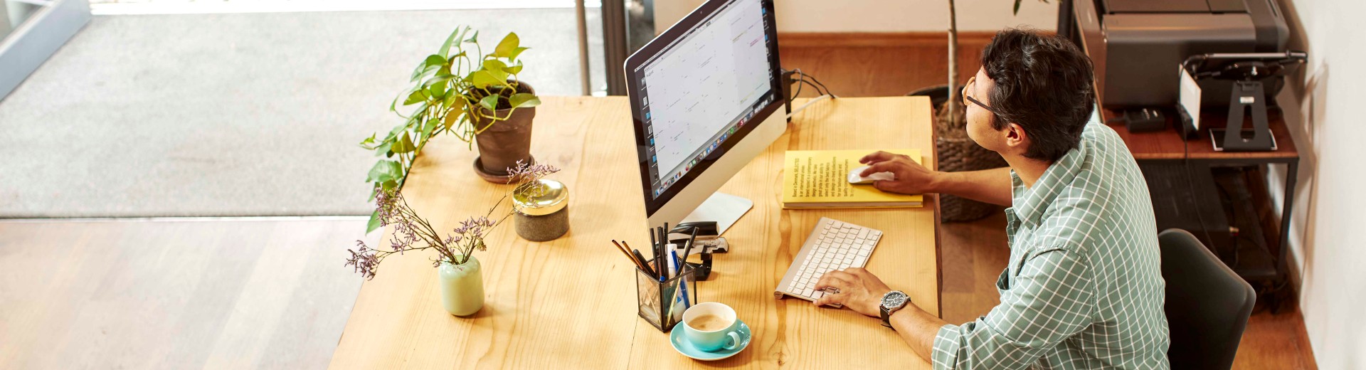 Man working on computer in shop