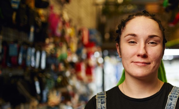 Happy_female_millennial_standing_in_gls_store