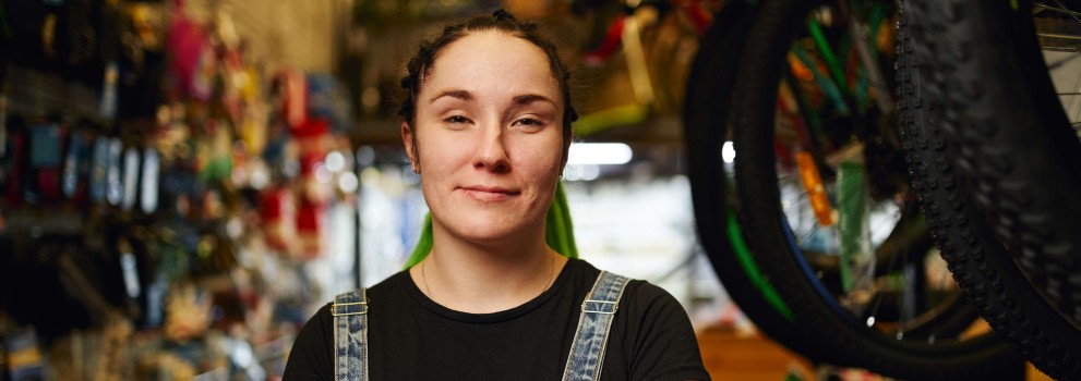 Happy_female_millennial_standing_in_gls_store