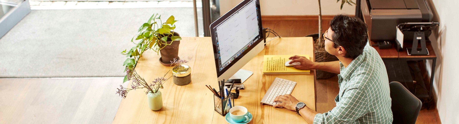 Man working on computer in shop