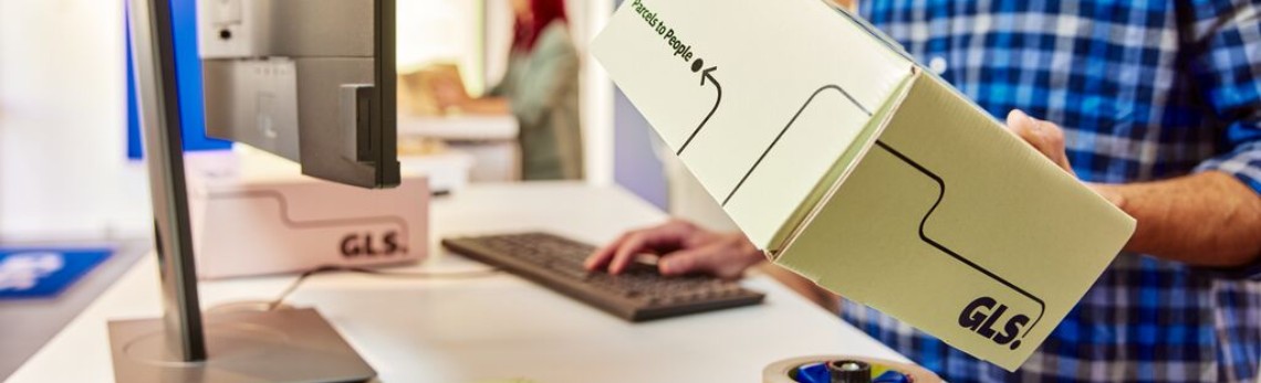 Bărbat deschide un colet GLS