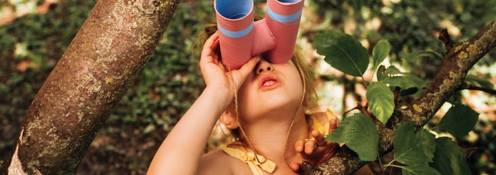 Punčka z daljnogledom se igra na drevesu